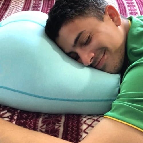 Man smiling on pillow.