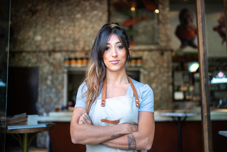 woman with her arms crossed working