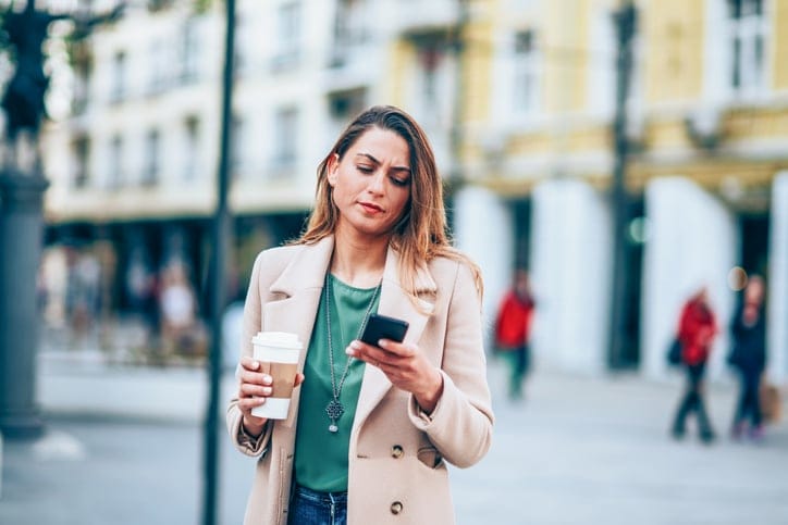 woman in street texting