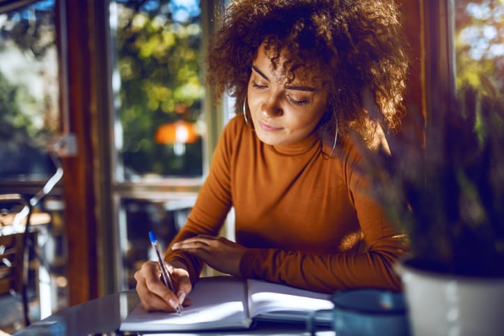 Student sitting in cafe and studying for exams.