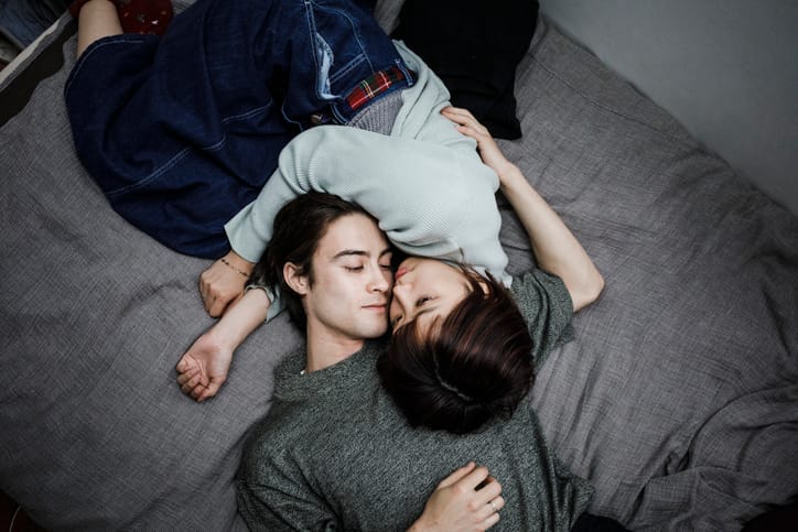 asian couple laying down