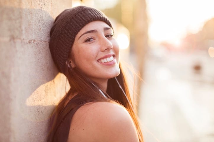smiling woman with a hat on