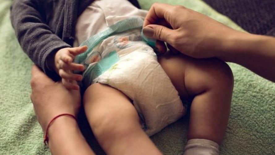 Baby having his diaper changed.