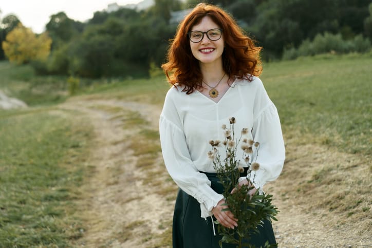Beautiful young woman with red curly hair