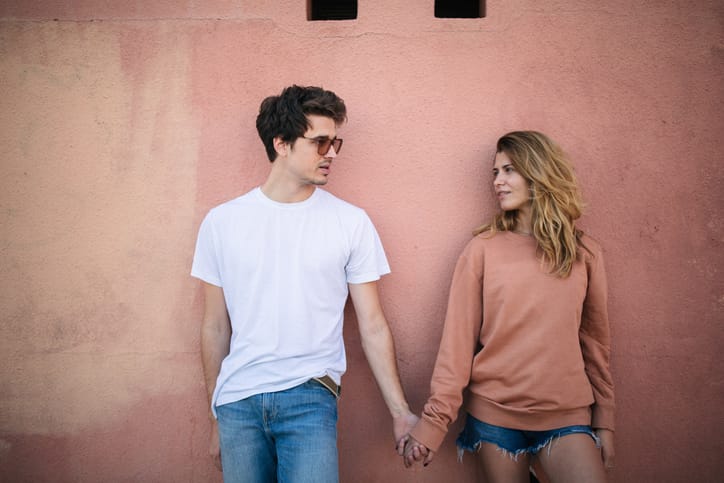 Cute teenage couple holding hands
