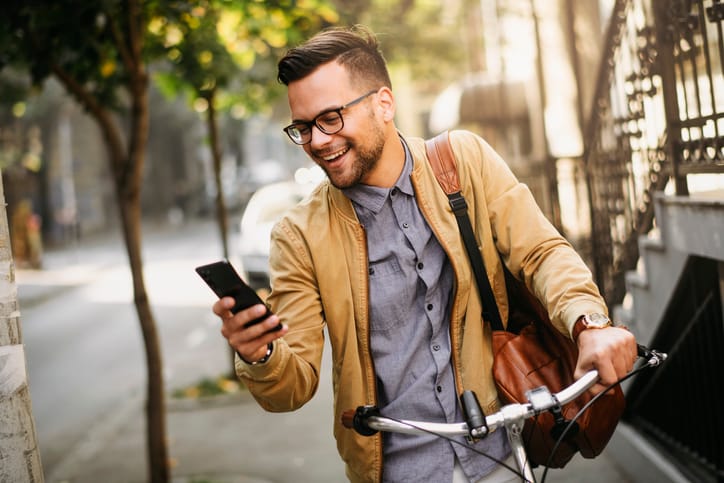 attractive man on bike texting