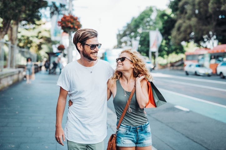 happy couple walking round the street