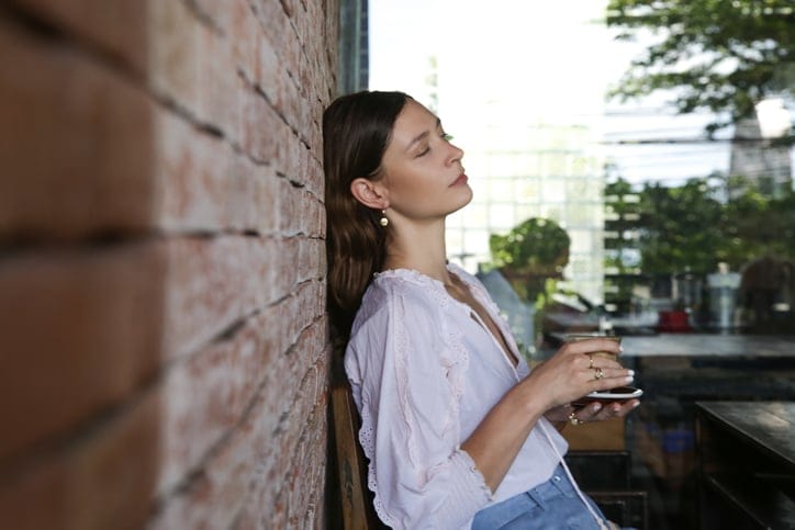 woman leaning against a wall