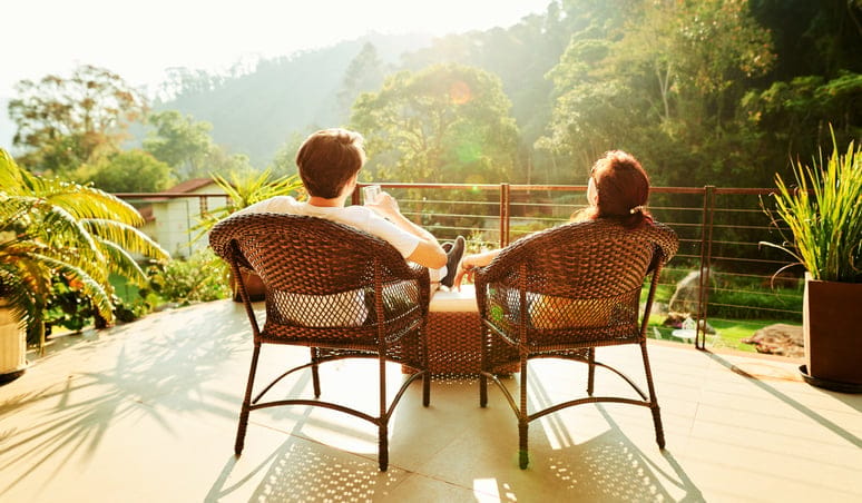 Couple relaxing on a hotel balcony.