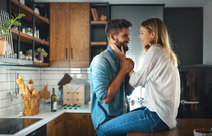 couple kissing in the kitchen
