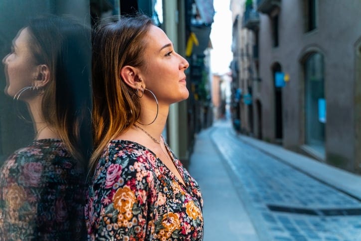 Woman standing outside alone.