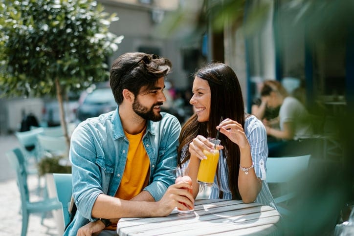 couple outside table drinking