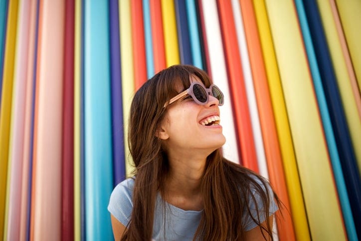 woman smiling striped background