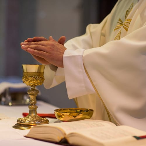 Priest with the body and blood of Christ.