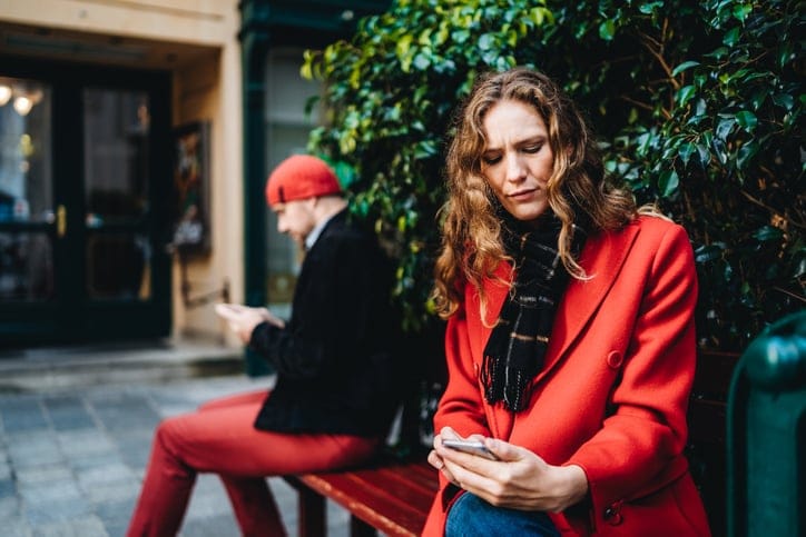 woman texting red coat