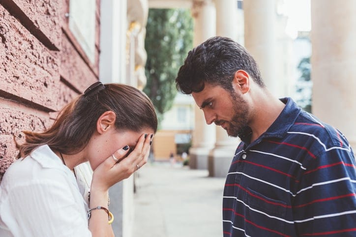 Young couple breaking up at the street