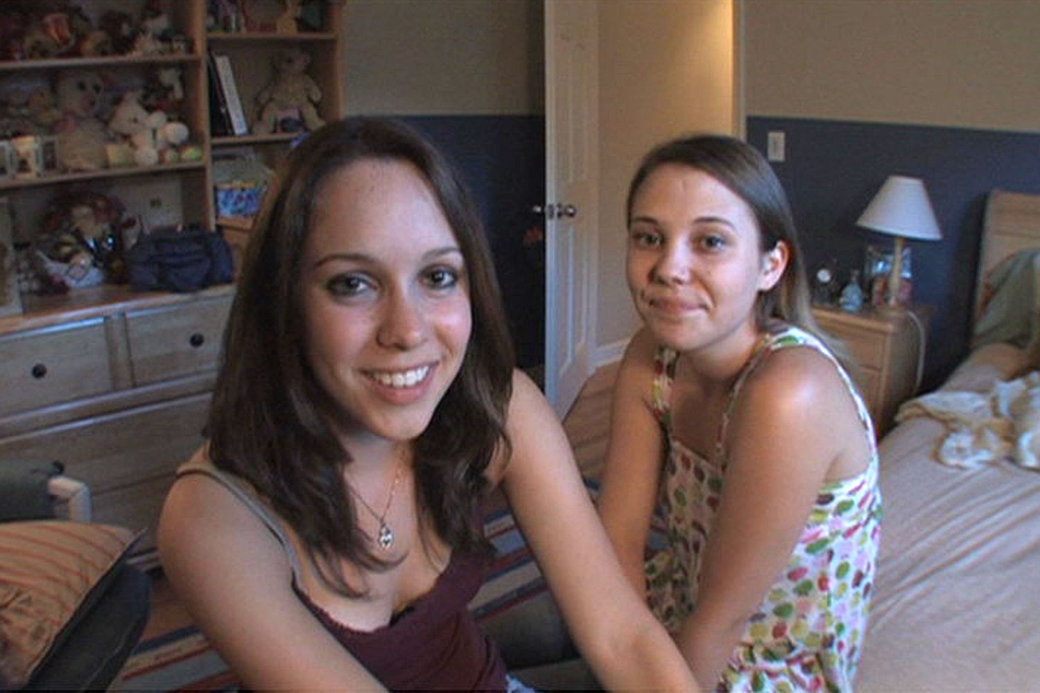 two young girls smiling at the camera