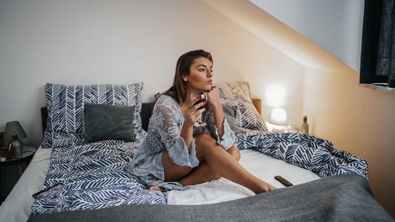woman sitting on the bed alone