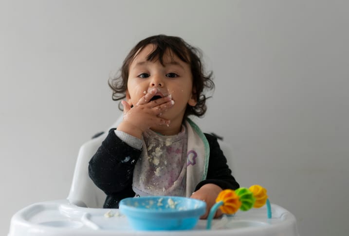 Child eating with hands.