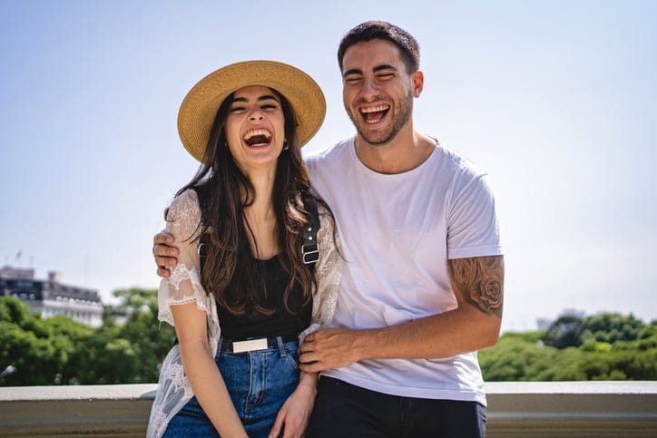couple laughing outside in the summer