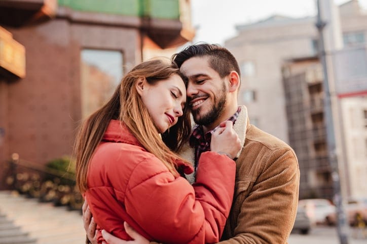 couple hugging each other outside