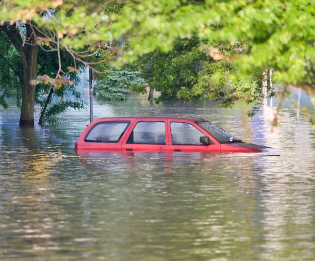 A flooded car in the city.