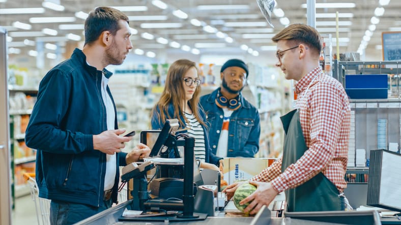 At the Supermarket Customer Pays with Smartphone.