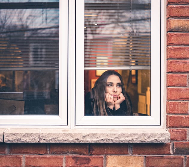 sad woman looking out window
