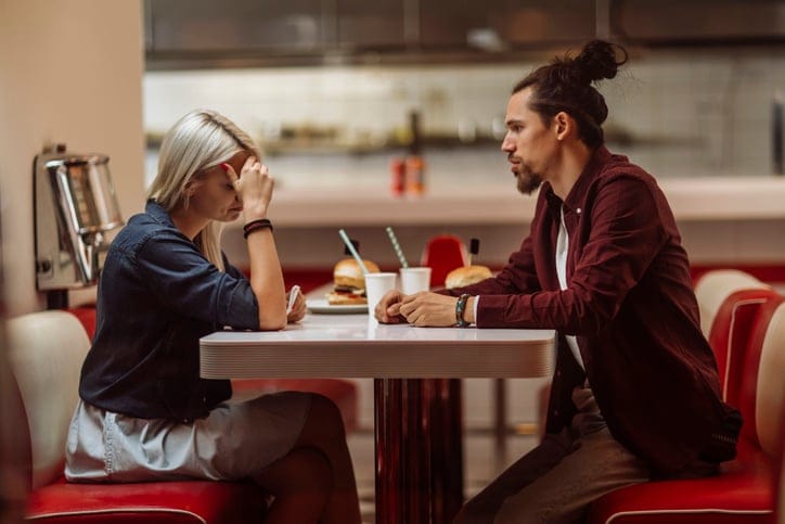 couple sitting at table having difficulties