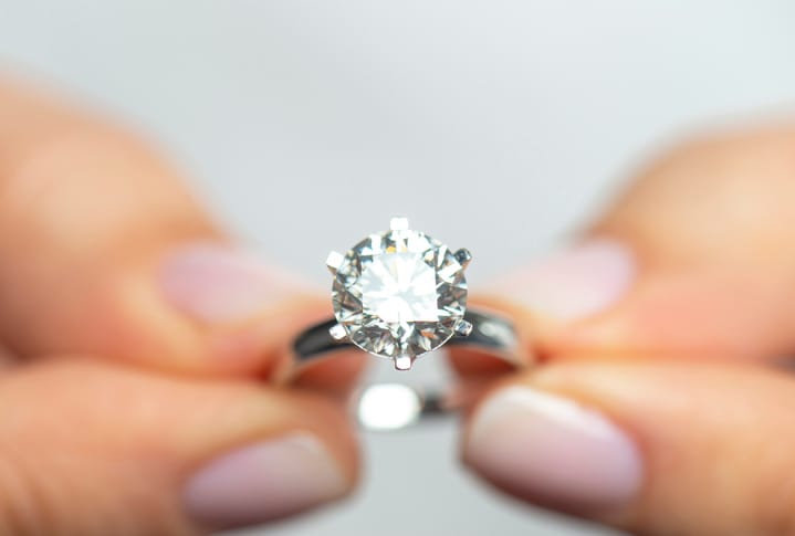 holding an engagement ring
