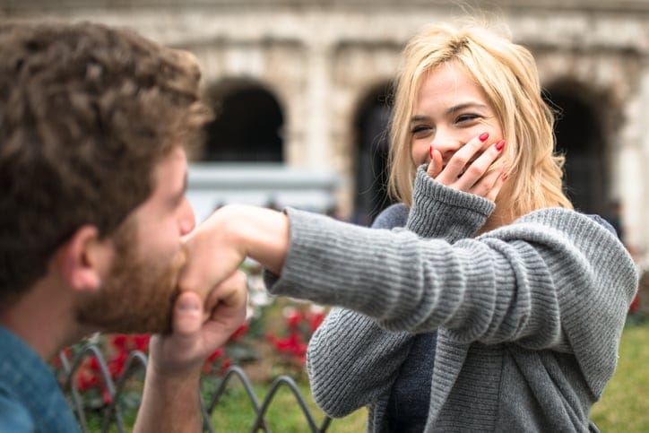 guy kissing woman's hand