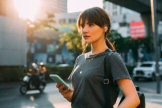 brunette woman in the city texting