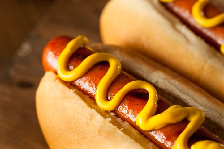 Hot dogs with mustard.