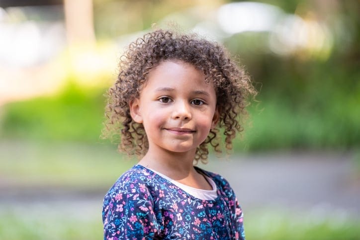 mixed race child with curly hair