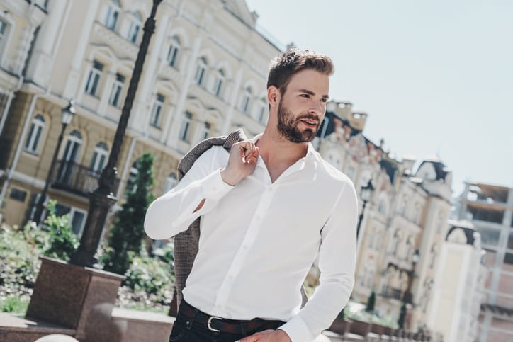 man in white shirt walking outside