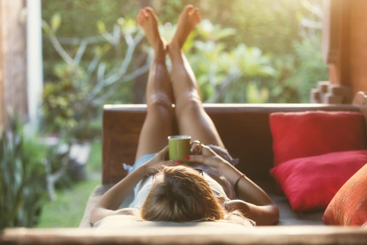 Woman laying in bed being lazy.
