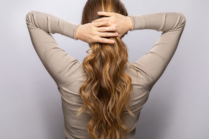 Woman putting her hair up.