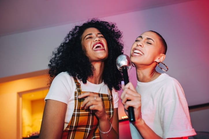 two best friends doing karaoke