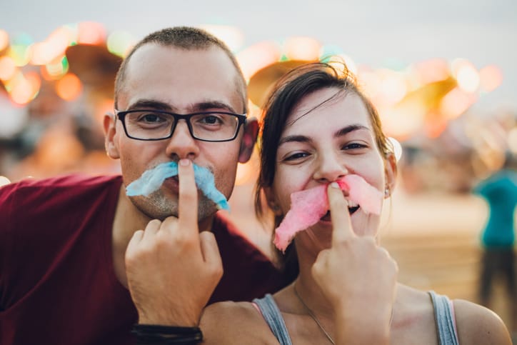 Happy couple in an amusement park.