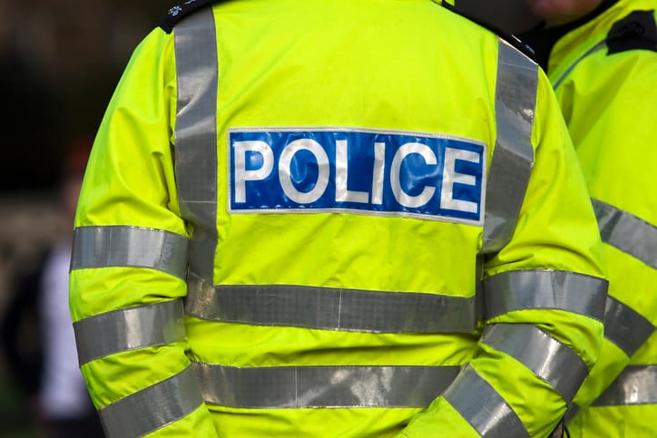 Policeman standing in uniform.