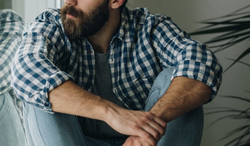 bearded man sitting down