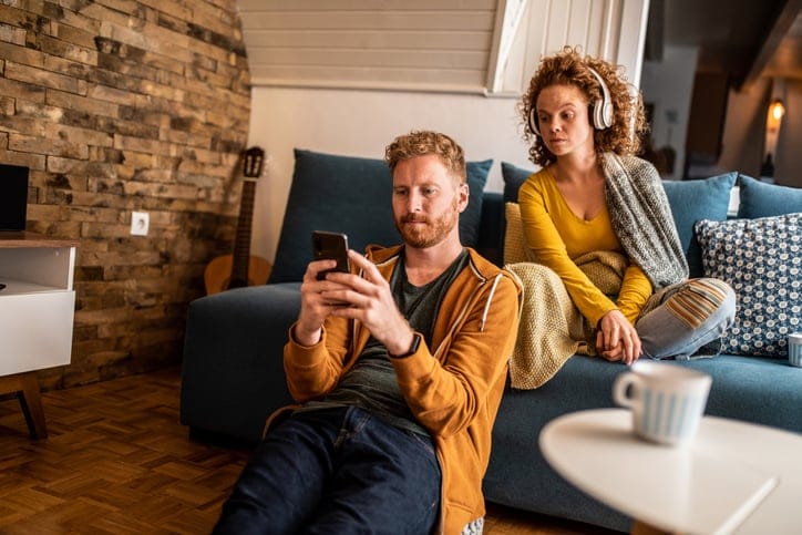Jealous woman checking her boyfriend's phone.