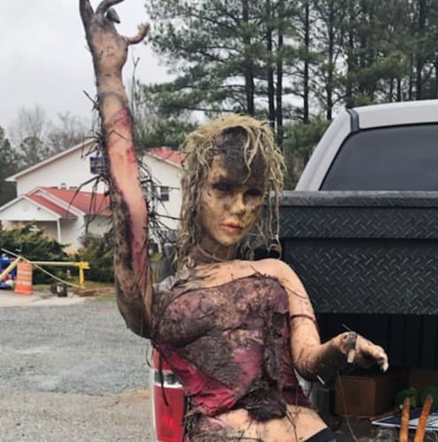sex doll covered in mud