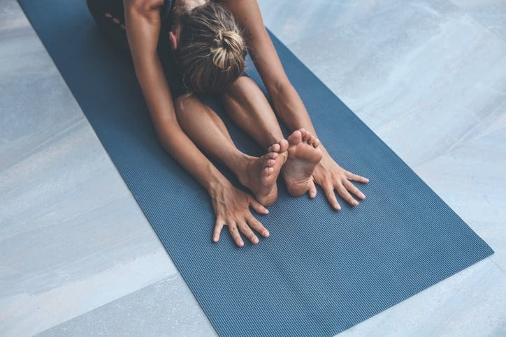 Woman doing yoga exercises at home.