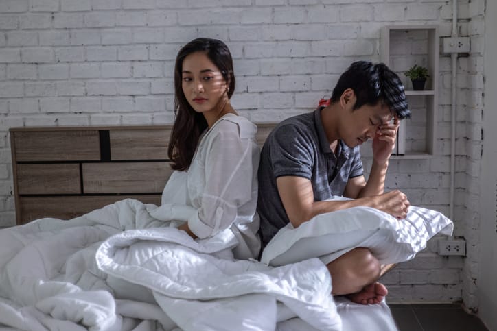 upset couple after fight in bed
