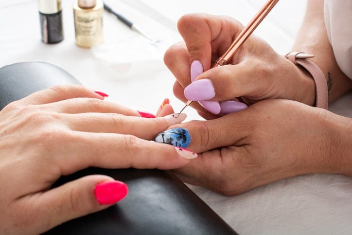 Woman getting her nails done.