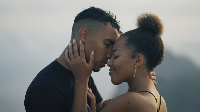 couple sharing romantic kiss outdoors