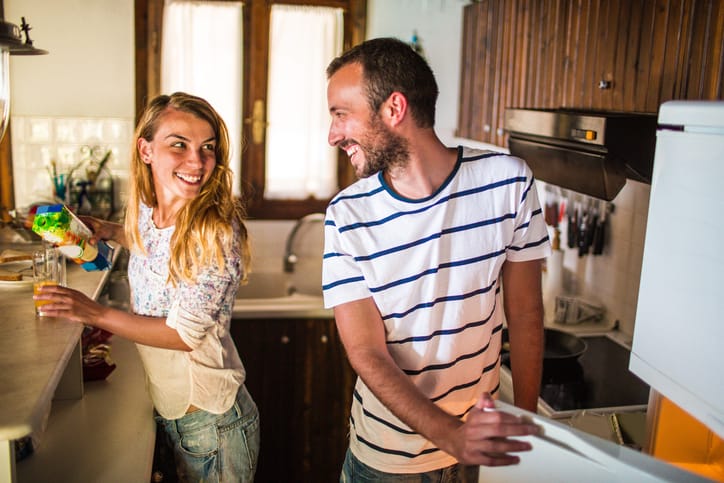 Couple making breakfast in the kitchen.