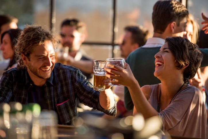 couple laughing over dinner outdoors