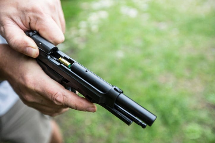 person holding a firearm